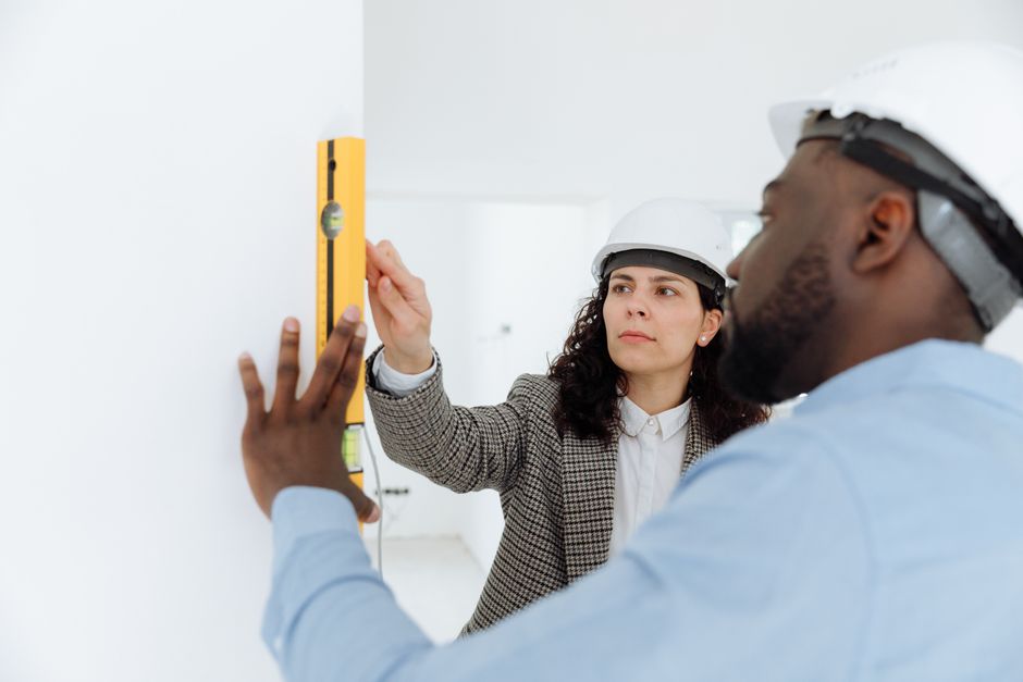 Professional contractors discussing plans with tools and materials